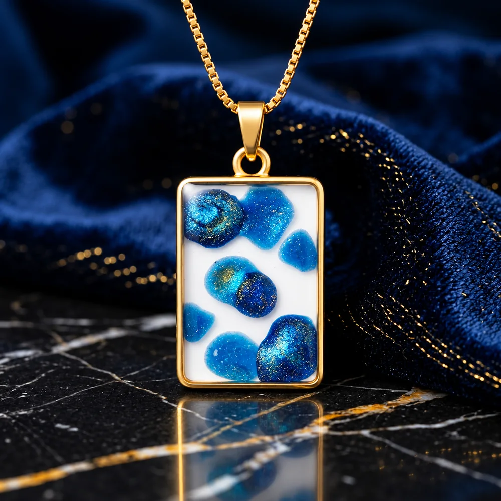 The Azure Lagoon Frame Necklace — Handcrafted Blue Glitter Droplet & White Resin Rectangular Pendant on a Gold-Toned Box Chain